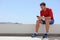 Athlete man watching video on phone screen at home or outdoor gym. Technology and sports athlete holding cellphone. Happy fit