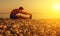 Athlete practicing, yoga on the beach at sunset