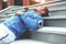 Athlete resting on the stairs after jogging, lying on the street, armband with phone and earphones with music for training