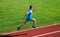 Athlete run track grass background. Sprinter training at stadium track. Runner captured in midair. Short distance