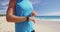 Athlete runner checking cardio on sports smartwatch jogging on beach outdoor