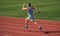 athlete runner do aerobic or anaerobic load. man start running on stadium. fitness gym outdoor. muscular athletic runner