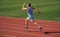 athlete runner do aerobic or anaerobic load. man start running on stadium. fitness gym outdoor. muscular athletic runner