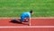 Athlete runner prepare to race. Running tips for beginners. Man athlete stand low start position stadium path. Runner
