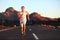 Athlete running sprinting at sunset on road