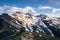 Athlete runs on a footpath on the Austrian mountain TÃ¶rlkopf overlooking the highest peak of the Grossglockner with rest of the