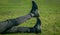 Athlete`s legs in leggings and sneakers, lying on the ground on the lawn close-up. crossed legs. training on the outdoors. warm-u