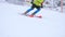 Athlete skiing on snowy sloping hill at ski resort