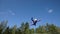 Athlete In Skydiving Suit Performs Stunt Above Vertical Wind Tunnel.