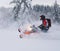 Athlete on a snowmobile moving in the winter forest