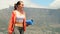 a athlete sport woman walks along a mountain road in a park with a yoga mat