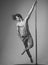 Athlete, sportsman performing pole dancing moves, work out, show trick.