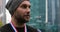 Athlete standing with three gold medals hanging from a red white and blue ribbon