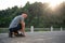 An athlete, strong Asian male runner is getting ready to run, exercising outdoors in the morning