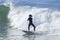 Athlete surfing on Santa Cruz beach in California