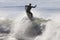 Athlete surfing on Santa Cruz beach in California