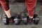 Athlete taking dumbbells from floor, man pov