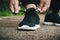 Athlete ties up shoelaces on sneakers before training in the open air