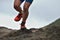 Athlete trail running in the mountains on rocky terrain