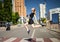 Athlete trail running woman runner silhouette in city on crosswalk. Cardio fitness training female athlete marathon race.