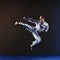 Athlete trains a kick in jump with blue overlays on hands