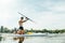 Athlete trains on a sup board, swims on the river and paddles. Surfing on the sup board as a hobby