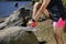 Athlete tying tennis laces on the shore of a lake