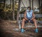 Athlete with virus protection mask resting on a wooden bench