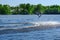 Athlete wakeboarder performs a jump with a somersault in the air