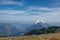 Athlete with the white-and-yellow parachute runs and then soars over Mount Krippenstein in upper Austria, enjoying the view of the