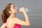 Athlete woman drinking water outdoors