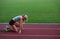 Athlete woman group running on athletics race track