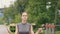 Athlete woman using skipping rope for outdoor workout in summer park