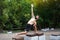 Athlete yogi man practicing yoga in a city park