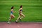 Athletes at 3000 meters race on a stadium 