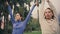 Athletes couple practicing yoga at nature closeup. Girls raising hands together