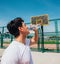 Athletes drinking water and having a break after a long exhausting basketball game