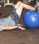 Athletes feet on blue balance ball in a gym