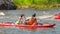 Athletes kayakers during training on whitewater. Man on inflatable stand up paddle board SUP