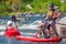 Athletes kayakers during training on whitewater. Man on inflatable stand up paddle board SUP