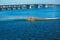 Athletes in kayaks in training near the river fountain in a rainbow of splashes