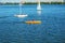 Athletes in kayaks in training near the river fountain in a rainbow of splashes