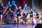 Athletes perform on stage, young cheerleaders perform at the cheerleading championship, girls in a jump, girls are holding pompons