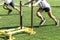 Athletes pushing weighted sleds on a turf field