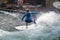 Athletes surfers train on an artificial permanent wave in the English Garden in Munich