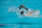 Athletes swimming freestyle on a swimming pool