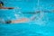 Athletes swimming freestyle on a swimming pool