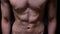 Athletic abs and torso of strong man with strained muscles on backgroung in studio