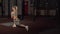 Athletic active woman doing stretching exercises in a Loft Style Industrial Gym