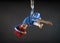 Athletic aerial circus artist with redhead in blue costume dancing in the air with balance